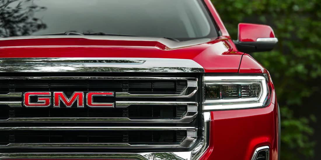 A front view of a red Acadia with grille