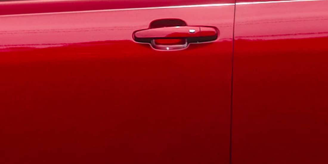 A red Acadia's outside door handle