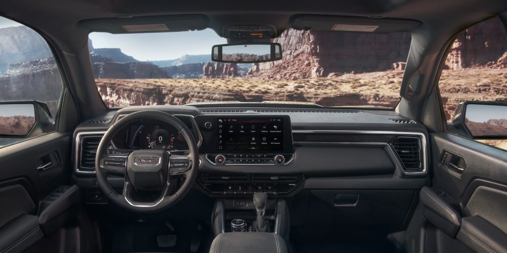 View of mountains through the widnshield of a 2023 GMC Canyon