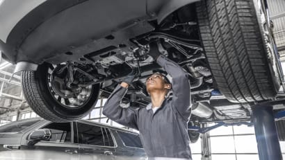 GM service technician under a vehicle