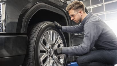 GM technician checking a tire