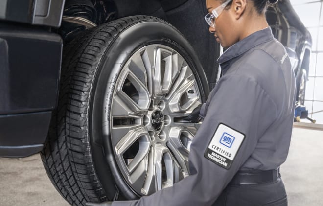 GM service technician mounting a wheel